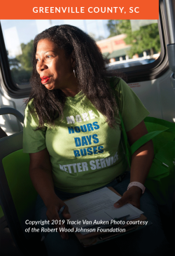 A woman on a bus prepares to attend a rally