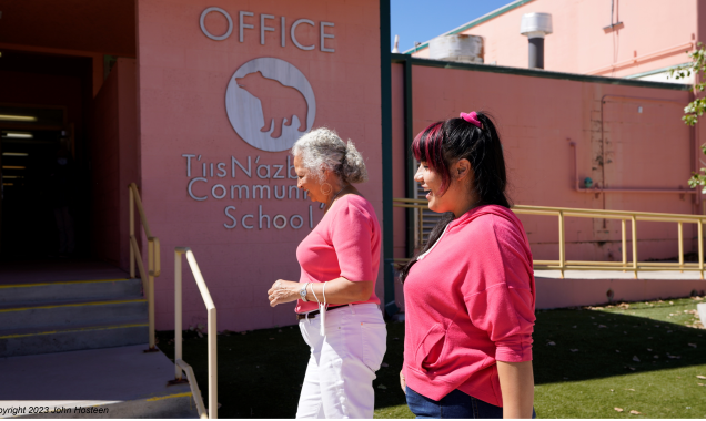 Two Native American women walking into a community school