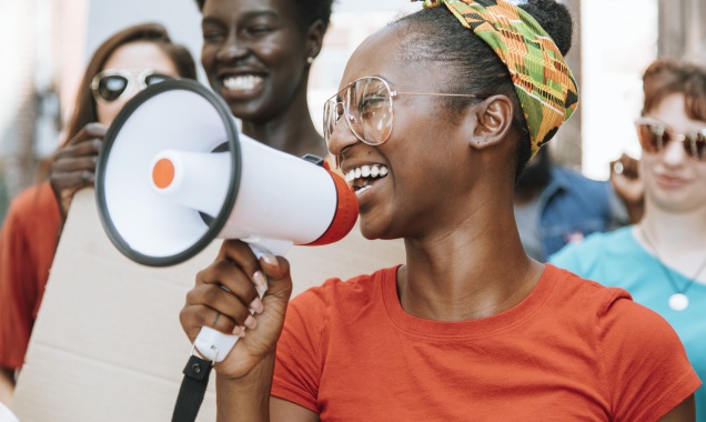 Woman in small crowd with megaphone