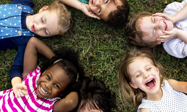 A group of children lay in a circle