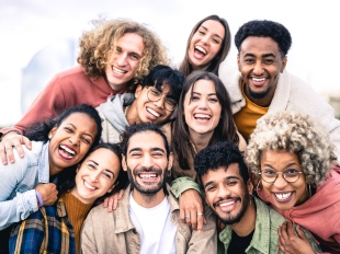 Group of people diverse in age, gender, and race taking a photo