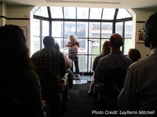 Judi J speaking before a crowd