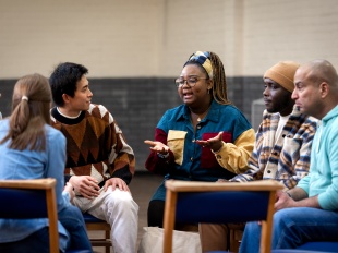 Six people sitting in a discussion circle