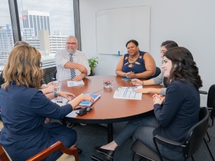 Staff members of the Health Policy Institute of Ohio working collaboratively around a large table in a conference room