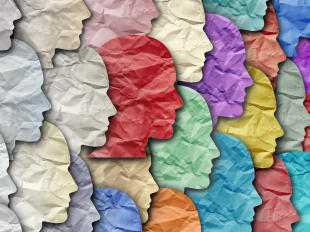 Stock photo of many paper faces cut from different colors of paper