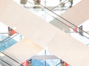 Crisscrossing escalators with people going in many directions