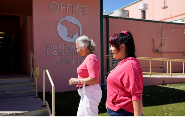 Two Native American women walking into a community school