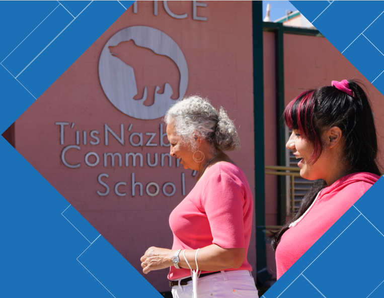 Two Native American women walking into a community school